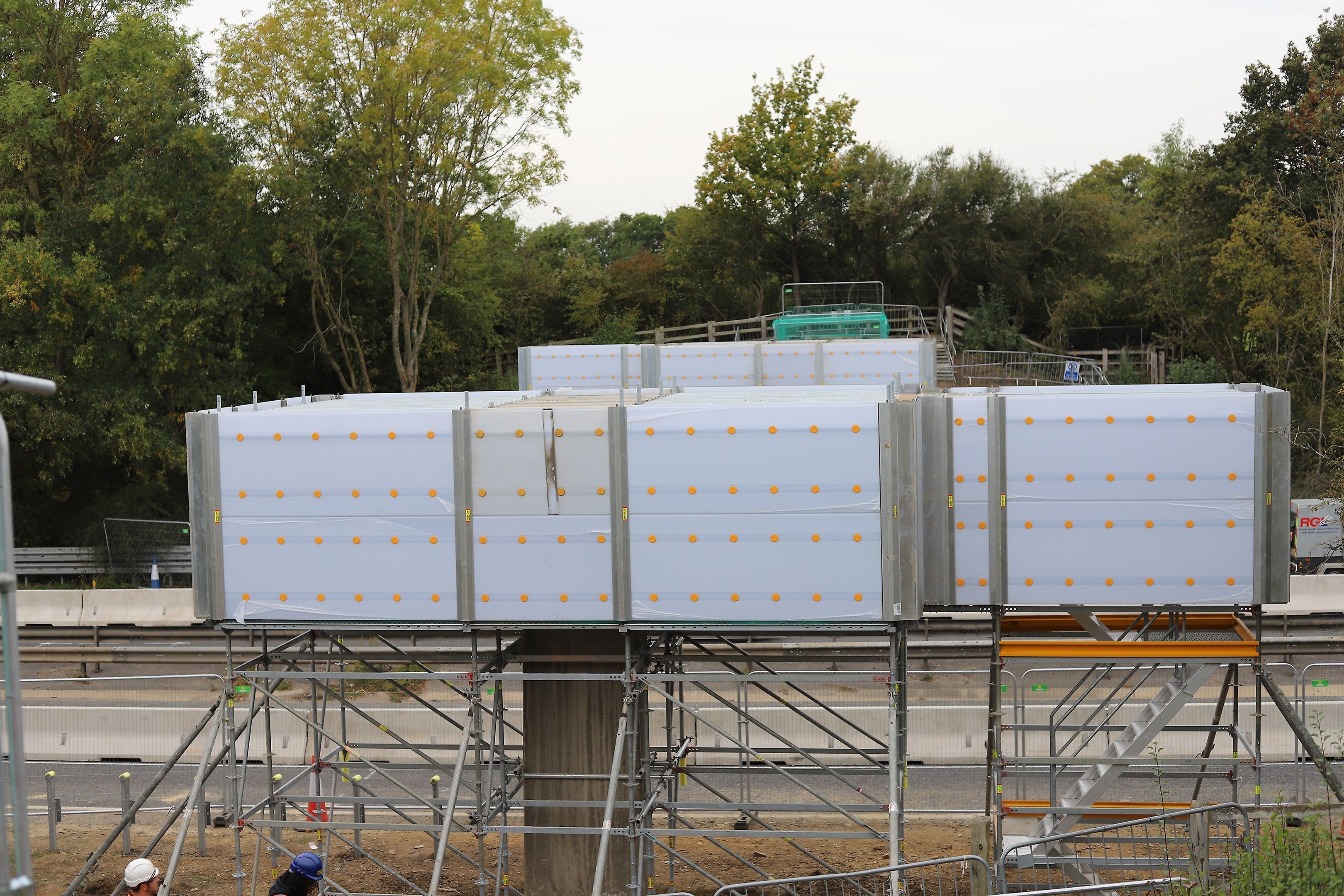 A full view of the PERI UP Cladding system enclosing the Old Cock Footbridge demolition site, showing how it provides a bright, secure, and dust-free working environment.