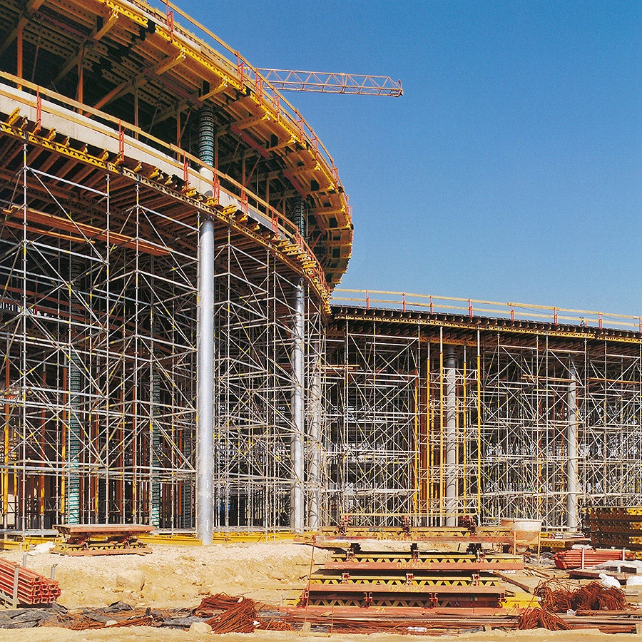 Slab formwork on PERI UP Rosett supporting scaffold for the slabs over the ground floor and cantilevered slab edge tables on the first floor.