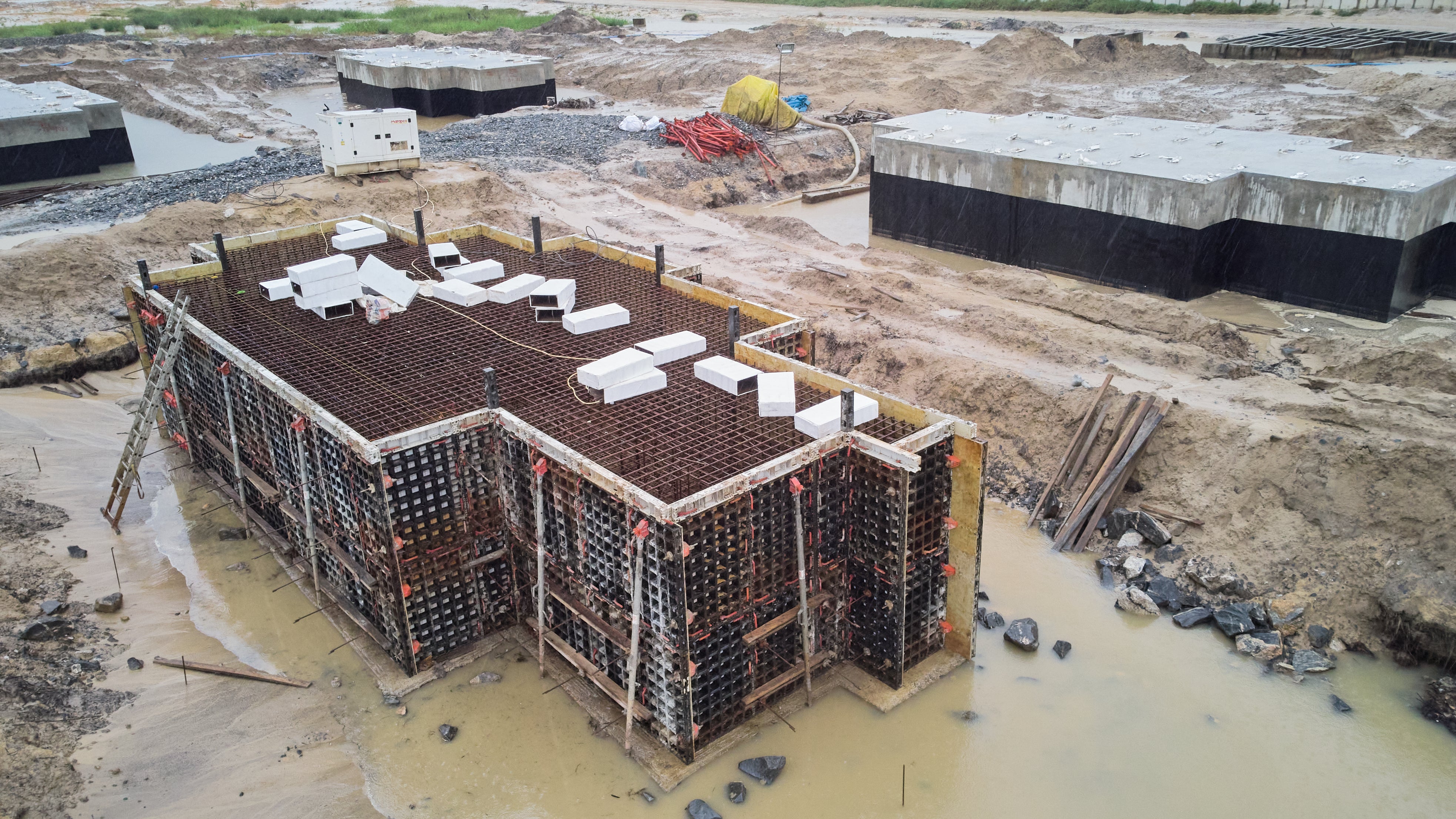 Construction of foundation blocks to carry gas compressor machinery. 180 cubic meter foundations with dimension 13m x 5m x 2.8m. The number of foundation blocks to be constructed is 10.